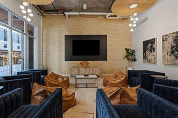 A modern living room with a flat screen tv mounted on the wall.